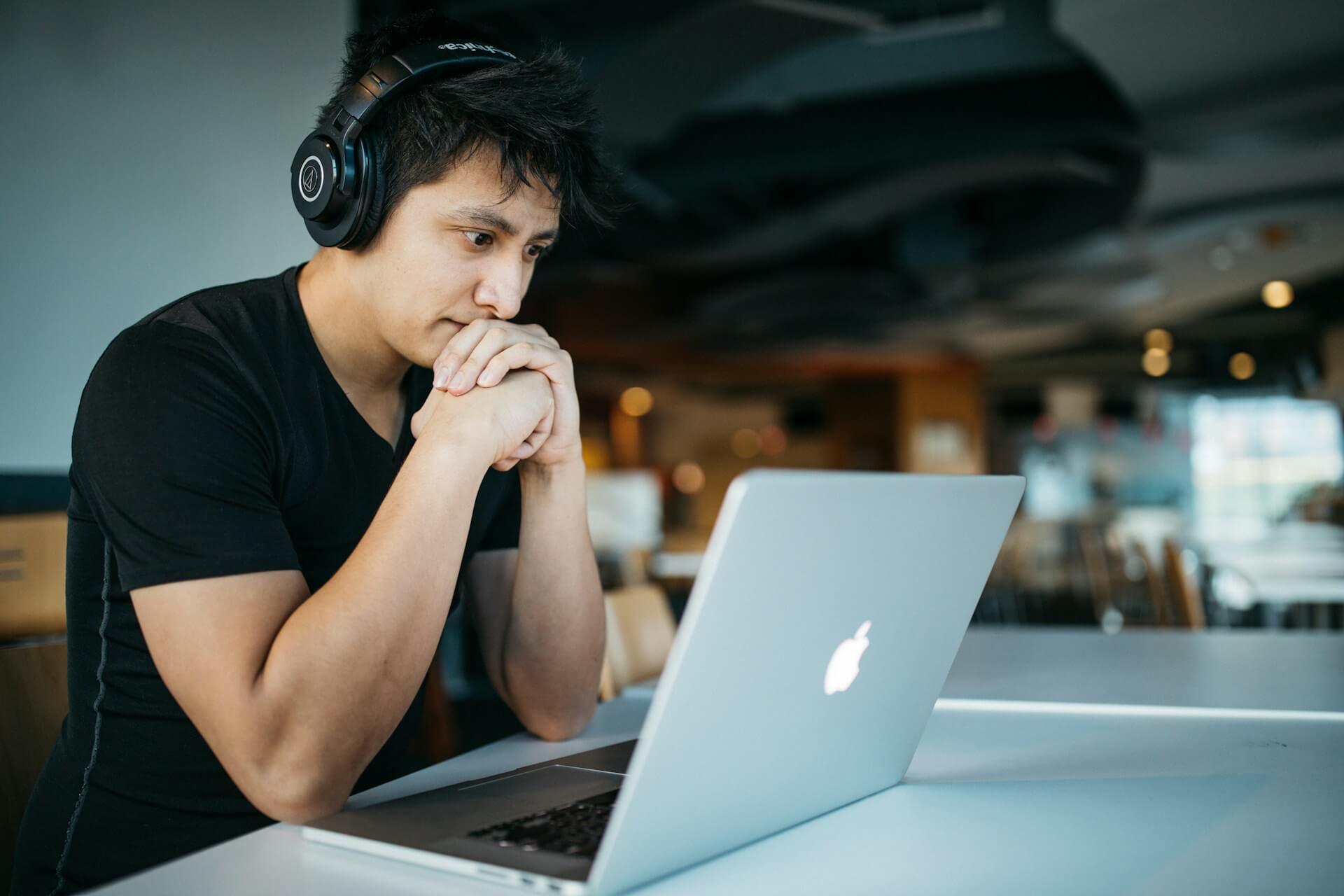 Man learning online skills on laptop for freelancing